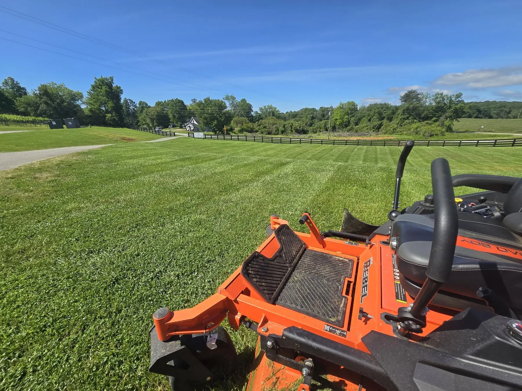 Maintained rural acreage with striped mowing and open fencing